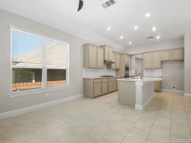 a kitchen with a cabinets and white appliances