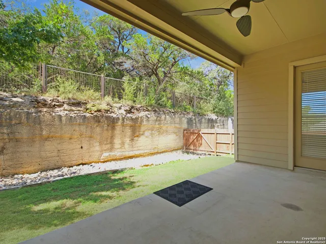 a backyard of a house with a yard and outdoor seating