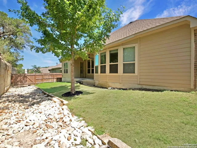 a backyard of a house with yard and outdoor seating