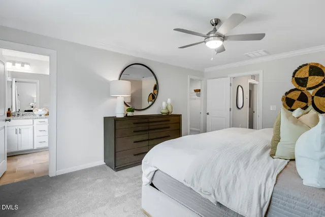 a bed sitting in a bedroom next to a window