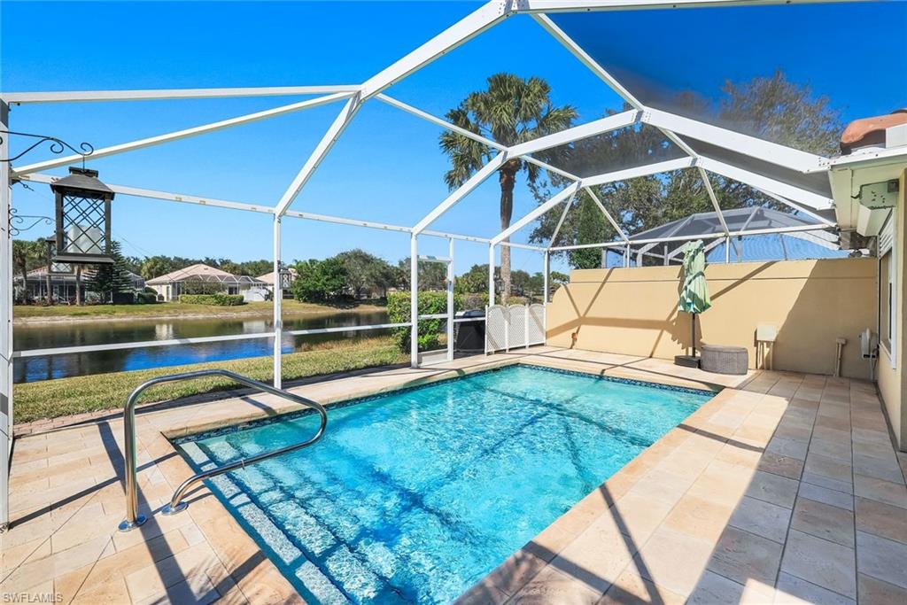 3025 Futuna Lane Naples, FL 34119 - Photo 2 of 46 Swimming pool featuring a sunroom, a patio area, a lanai, and a water view