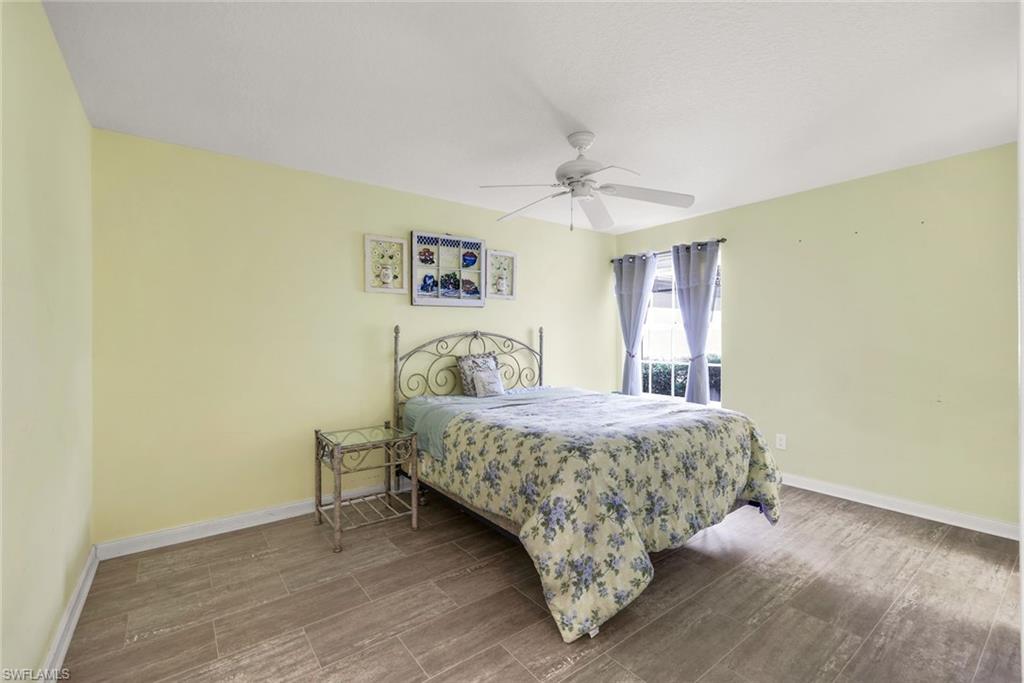 3025 Futuna Lane Naples, FL 34119 - Photo 23 of 46 Bedroom featuring wood finish floors and ceiling fan