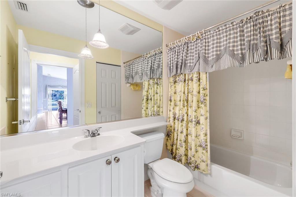3025 Futuna Lane Naples, FL 34119 - Photo 24 of 46 Bathroom featuring vanity and shower / tub combo with curtain