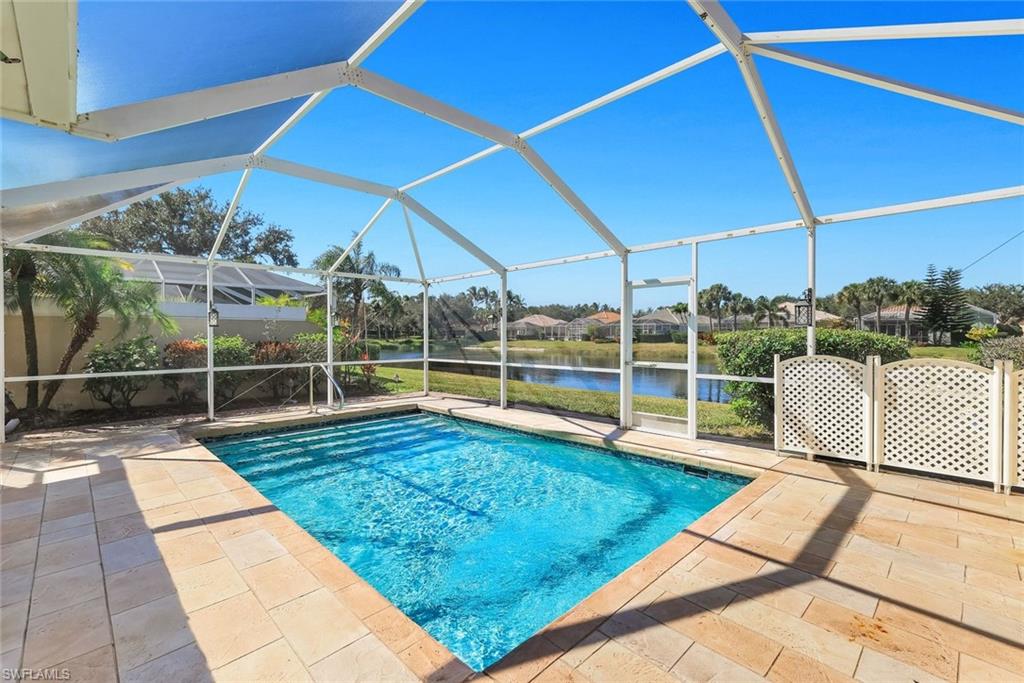 3025 Futuna Lane Naples, FL 34119 - Photo 6 of 46 Swimming pool featuring glass enclosure, a water view, a sunroom, a patio, and a residential view