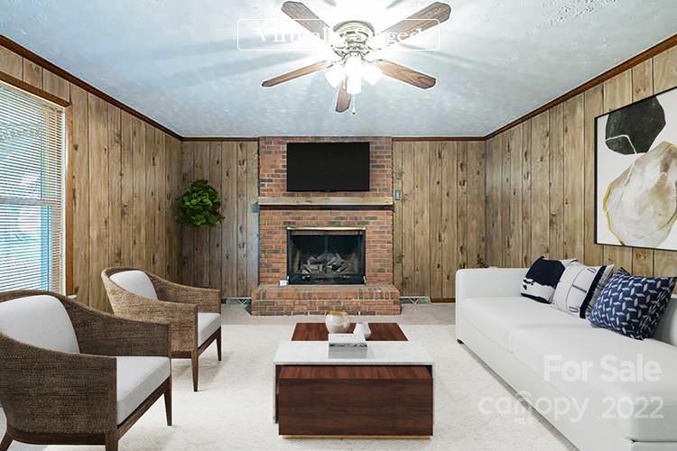 621 Rowan Mill Road Salisbury, NC 28147 - Photo 2 of 13 a living room with furniture a flat screen tv and a fireplace