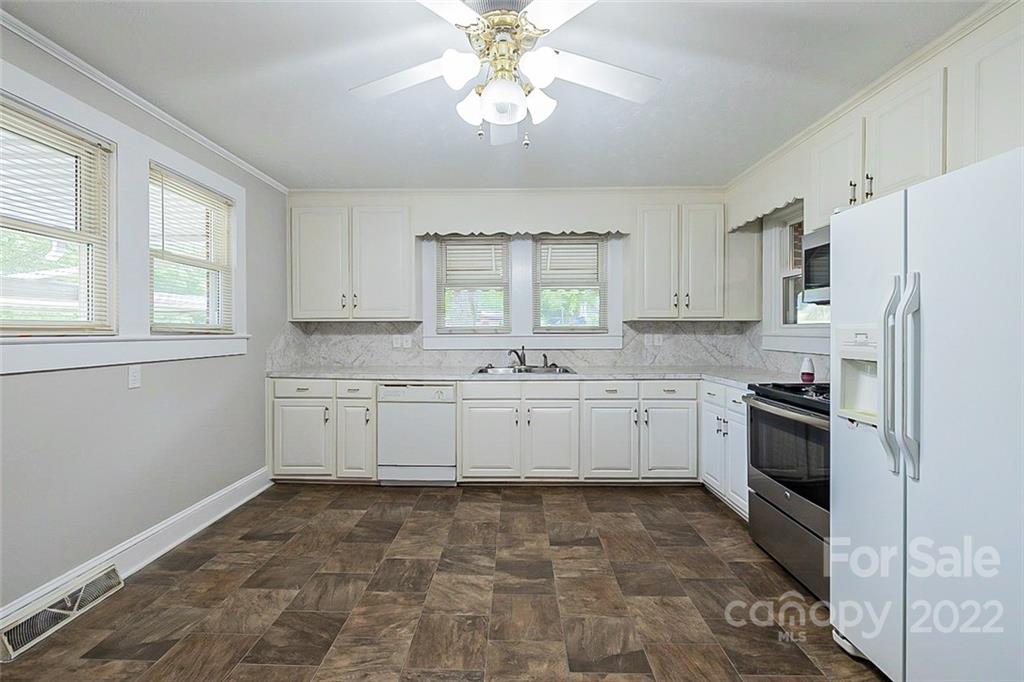 621 Rowan Mill Road Salisbury, NC 28147 - Photo 4 of 13 a kitchen with white cabinets and white appliances