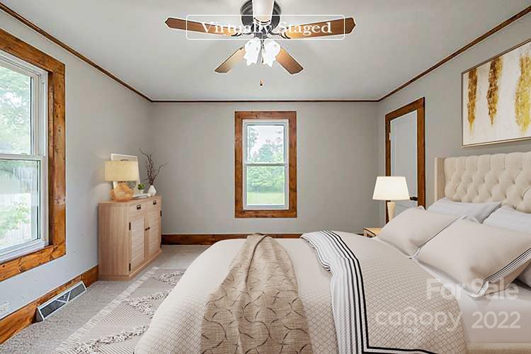 621 Rowan Mill Road Salisbury, NC 28147 - Photo 5 of 13 a bedroom with a large bed and a window