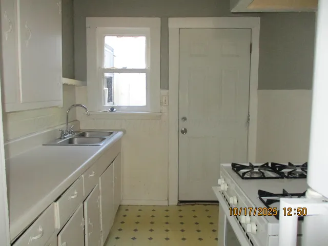 a bathroom with a sink a toilet and window