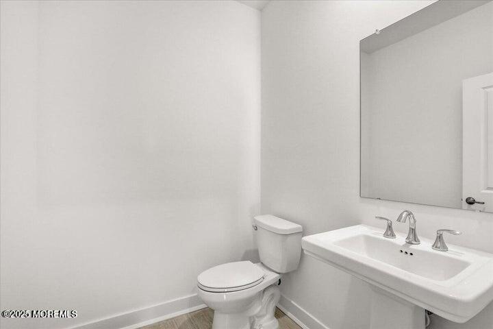 179 Woolley Court, Unit 1 Asbury Park, NJ 07712 - Photo 11 of 24 a bathroom with a sink and a toilet