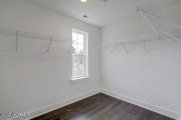 179 Woolley Court, Unit 1 Asbury Park, NJ 07712 - Photo 23 of 24 an empty room with wooden floor and windows