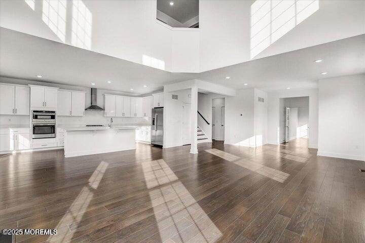 179 Woolley Court, Unit 1 Asbury Park, NJ 07712 - Photo 5 of 24 a view of kitchen with kitchen island a sink stainless steel appliances and cabinets