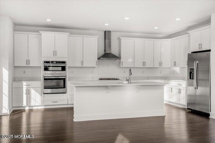 179 Woolley Court, Unit 1 Asbury Park, NJ 07712 - Photo 7 of 24 a kitchen with stainless steel appliances granite countertop a stove a sink and a refrigerator