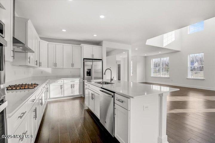 179 Woolley Court, Unit 1 Asbury Park, NJ 07712 - Photo 8 of 24 a kitchen with stainless steel appliances granite countertop a stove and a sink