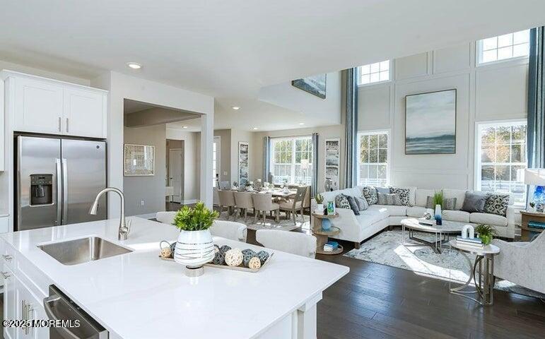179 Woolley Court, Unit 1 Asbury Park, NJ 07712 - Photo 9 of 24 a living room with furniture kitchen view and large windows