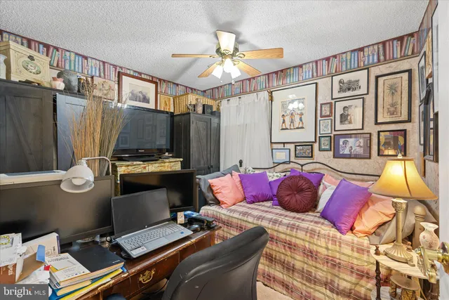 a bed room with a bed and a painting on the wall