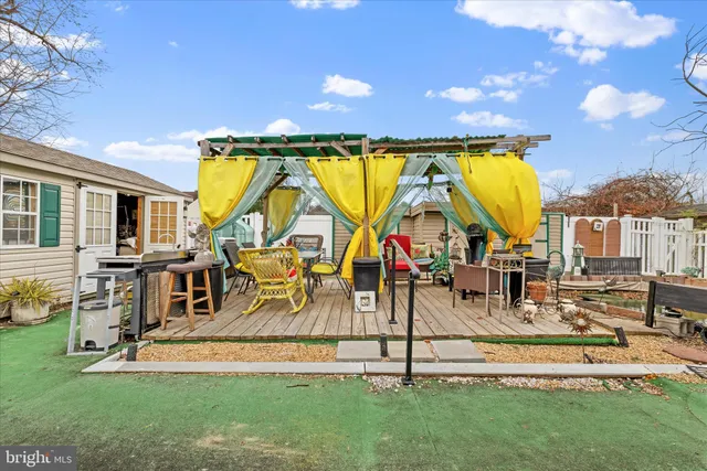 a view of a house with backyard sitting area and swimming pool