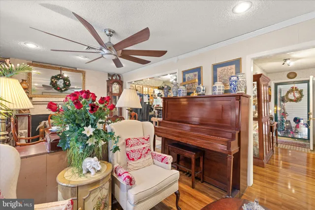 a dining room with furniture a large window and wooden floor