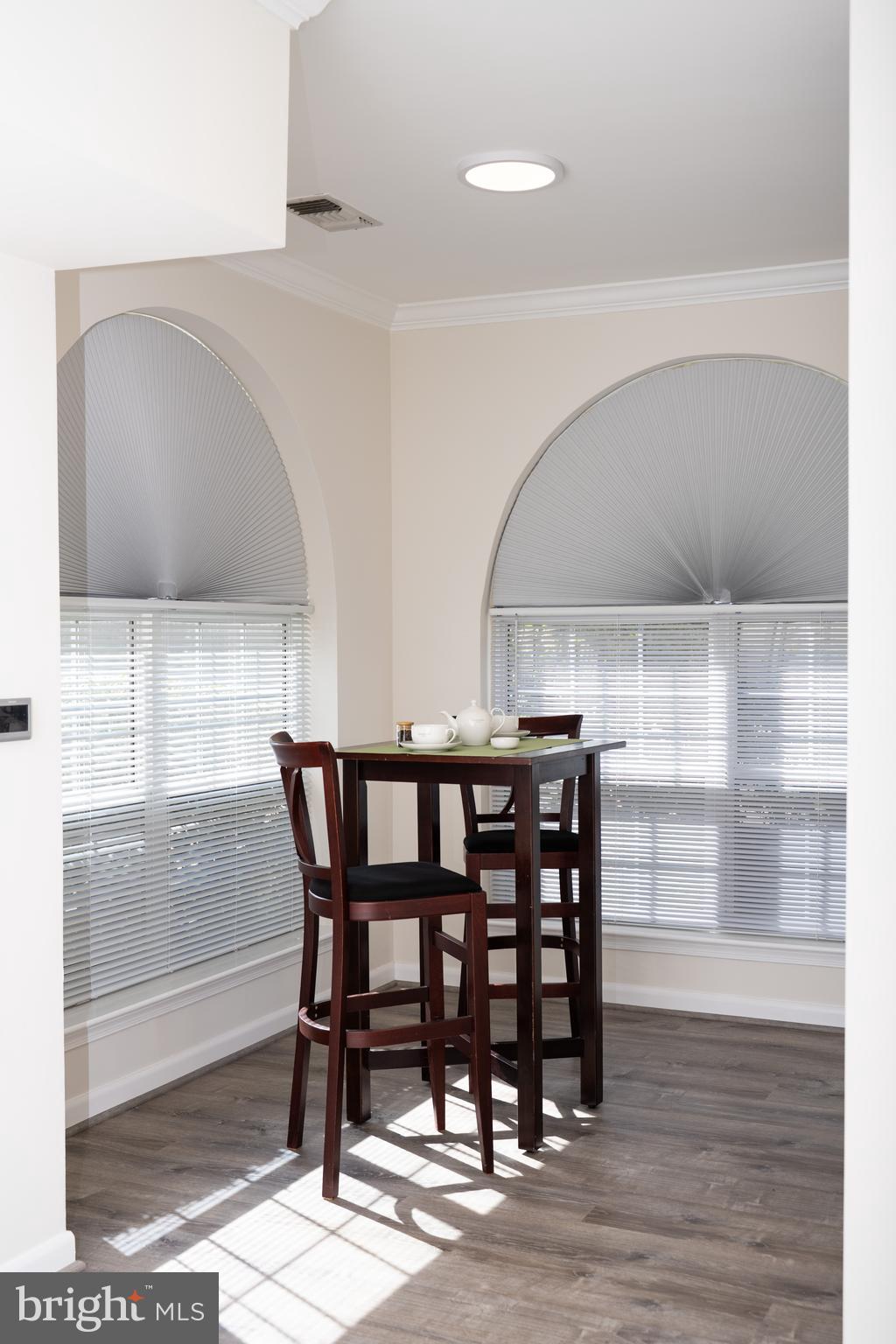 4561 Strutfield Lane, Unit 3115 Alexandria, VA 22311 - Photo 15 of 36 a view of a dining room with furniture and wooden floor