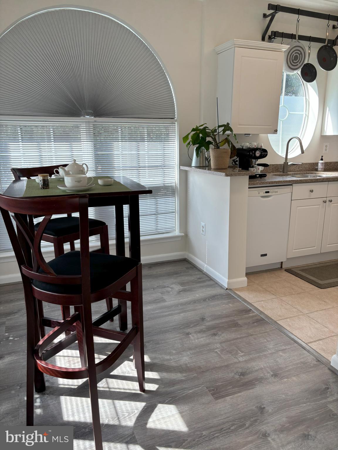 4561 Strutfield Lane, Unit 3115 Alexandria, VA 22311 - Photo 16 of 36 a kitchen with a wooden table and chairs