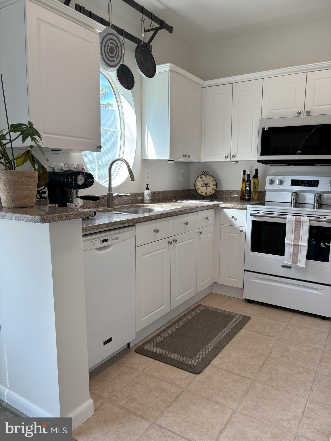 4561 Strutfield Lane, Unit 3115 Alexandria, VA 22311 - Photo 18 of 36 a kitchen with a sink cabinets and window