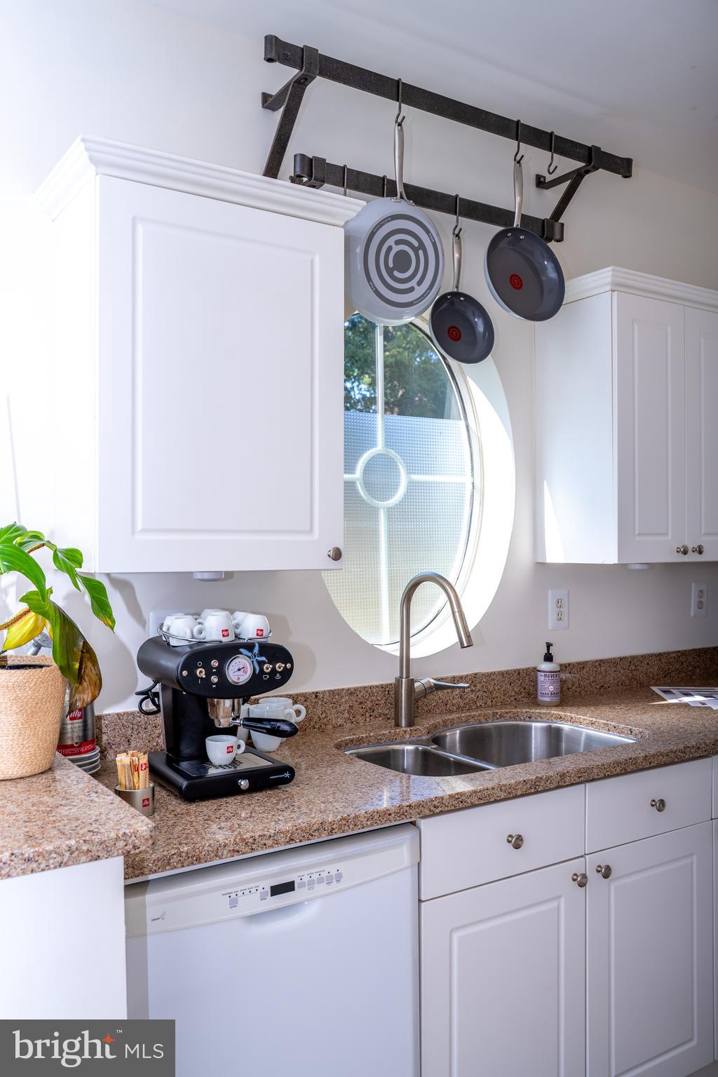 4561 Strutfield Lane, Unit 3115 Alexandria, VA 22311 - Photo 19 of 36 a kitchen with a sink a stove and cabinets