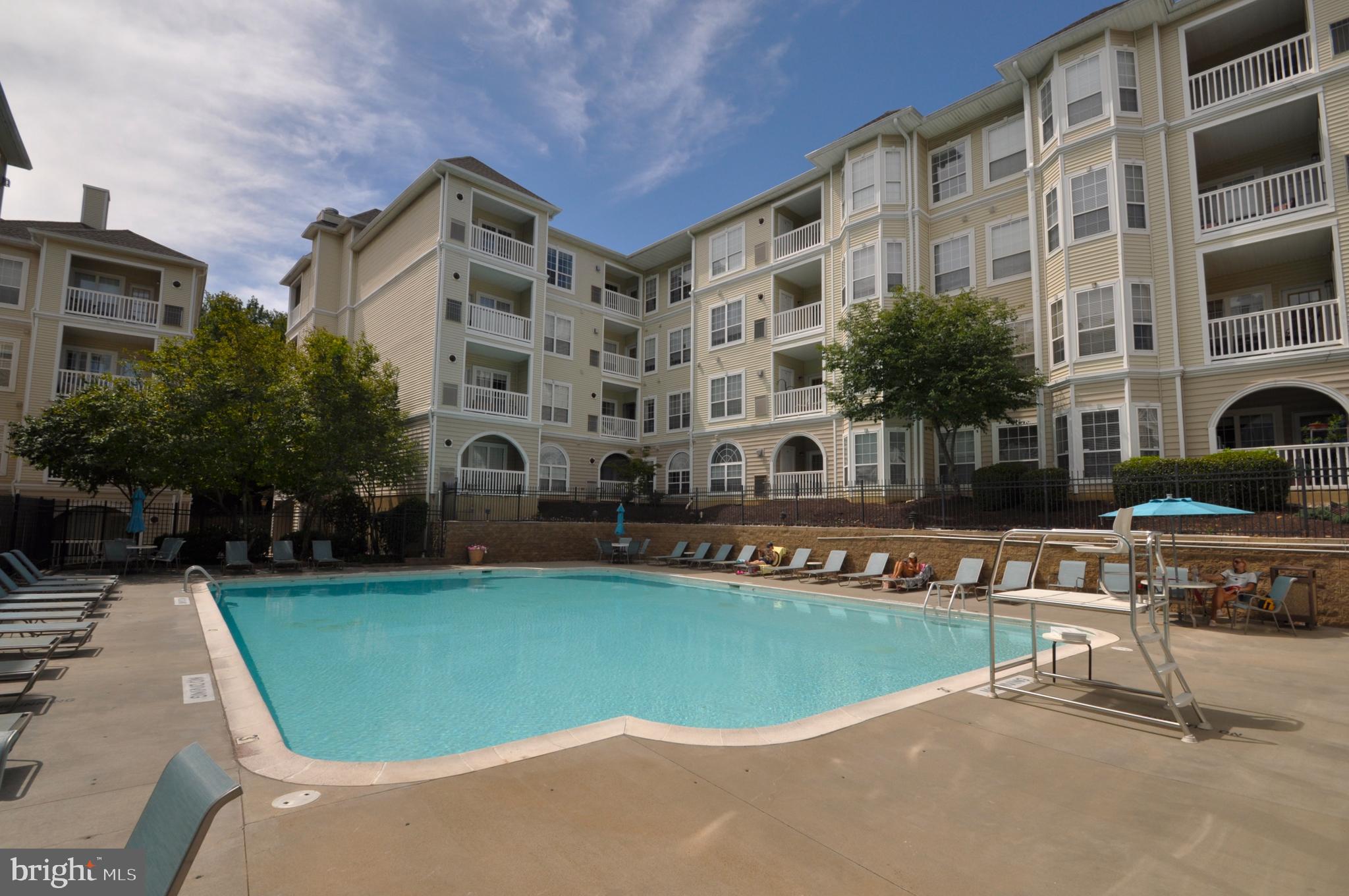 4561 Strutfield Lane, Unit 3115 Alexandria, VA 22311 - Photo 29 of 36 a front view of building with swimming pool and seating