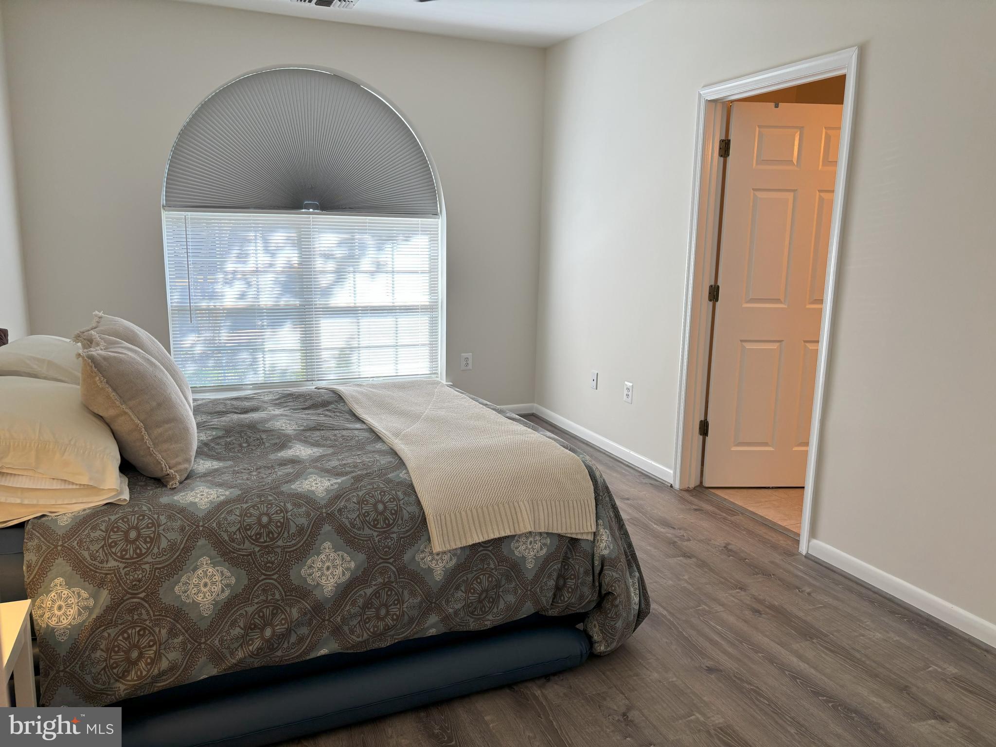 4561 Strutfield Lane, Unit 3115 Alexandria, VA 22311 - Photo 7 of 36 a bedroom with a bed and a window