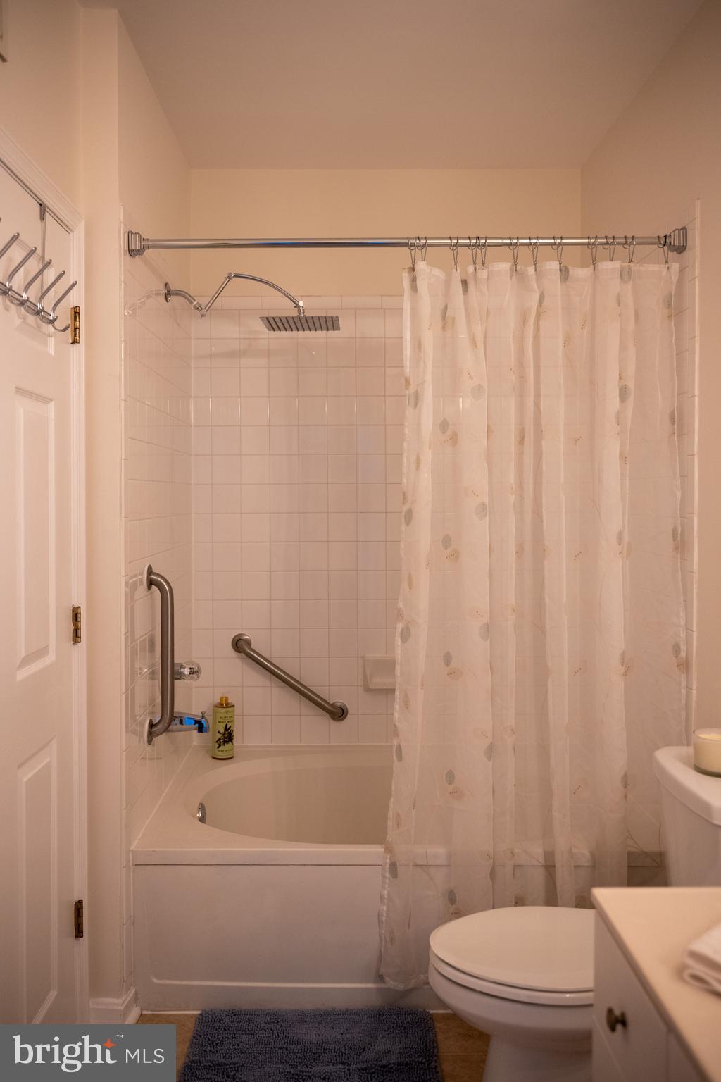 4561 Strutfield Lane, Unit 3115 Alexandria, VA 22311 - Photo 9 of 36 a bathroom with a sink a toilet and shower