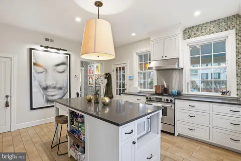 a kitchen with granite countertop a sink appliances and cabinets