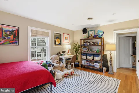 a bedroom with furniture and wooden floor