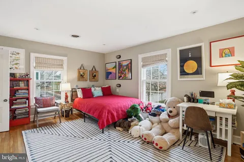a bedroom with furniture and a large window