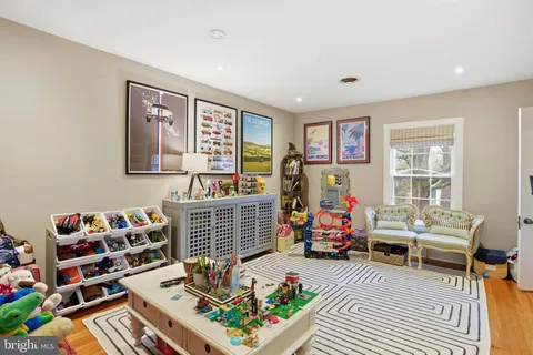 a bedroom with furniture toys and a book shelf