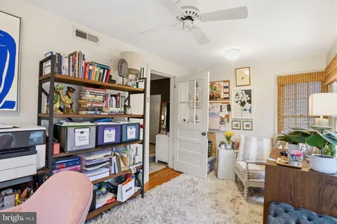 a living room with furniture and a book shelf
