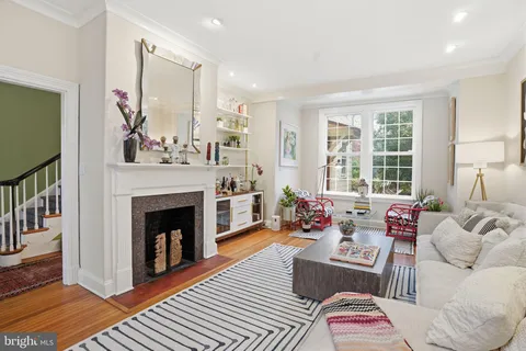 a living room with furniture a window and a fireplace