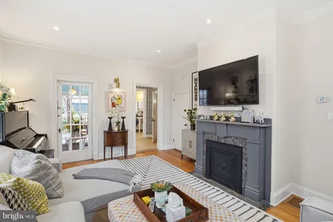 a living room with furniture a flat screen tv and a fireplace