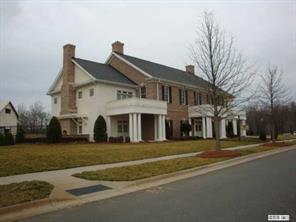 1724 Ridgehaven Road, Unit 220 Waxhaw, NC 28173 - Photo 14 of 16 a front view of a building with a garden