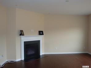 1724 Ridgehaven Road, Unit 220 Waxhaw, NC 28173 - Photo 3 of 16 a view of an empty room with wooden floor and a fireplace