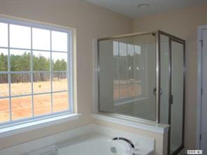 1724 Ridgehaven Road, Unit 220 Waxhaw, NC 28173 - Photo 8 of 16 a bathroom with a glass shower door and a bathtub
