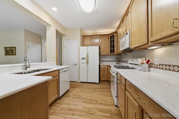 a kitchen with a sink a stove and a refrigerator