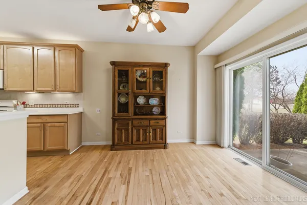 a kitchen with a wooden floor and window