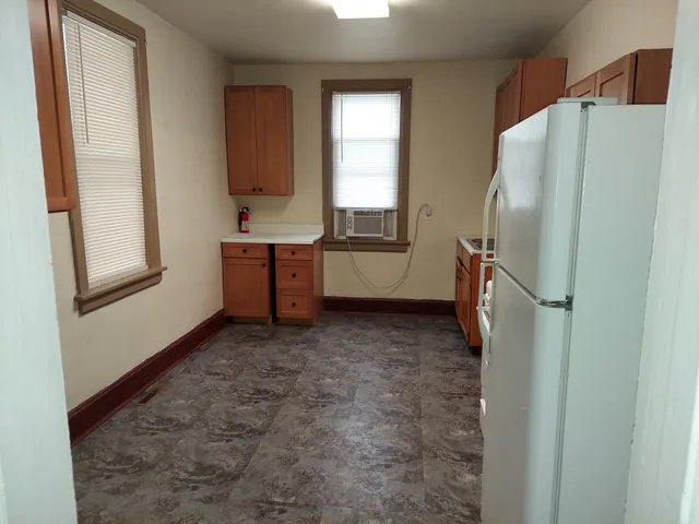 a kitchen with a refrigerator and a window