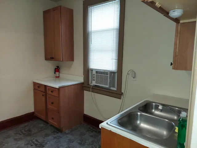 a kitchen with a sink and a mirror