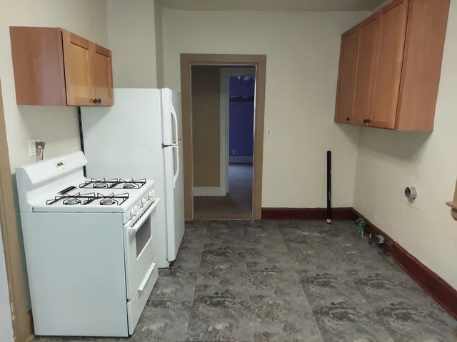 a kitchen with a stove and a refrigerator