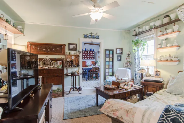 a living room with furniture a chandelier and a table