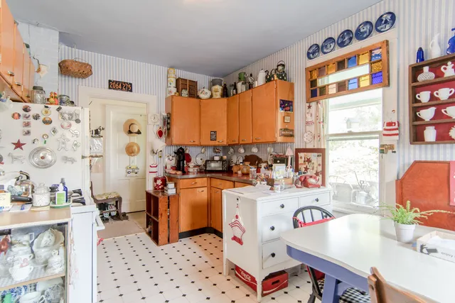 a room with stainless steel appliances a sink a stove a refrigerator and a window