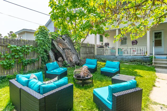 a view of backyard of house with outdoor seating