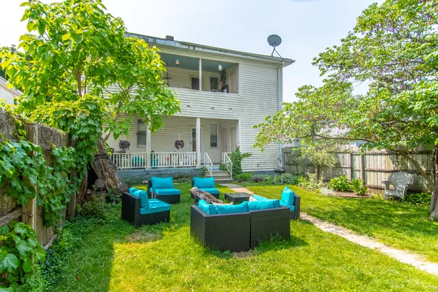 a backyard of a house with outdoor seating