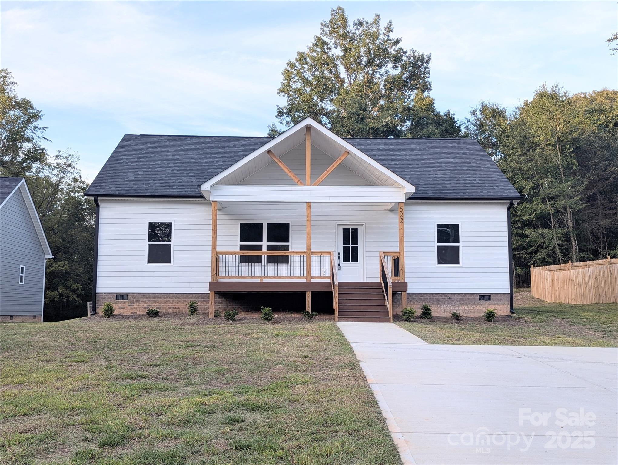 a house view with a sitting space fire pit and outdoor space