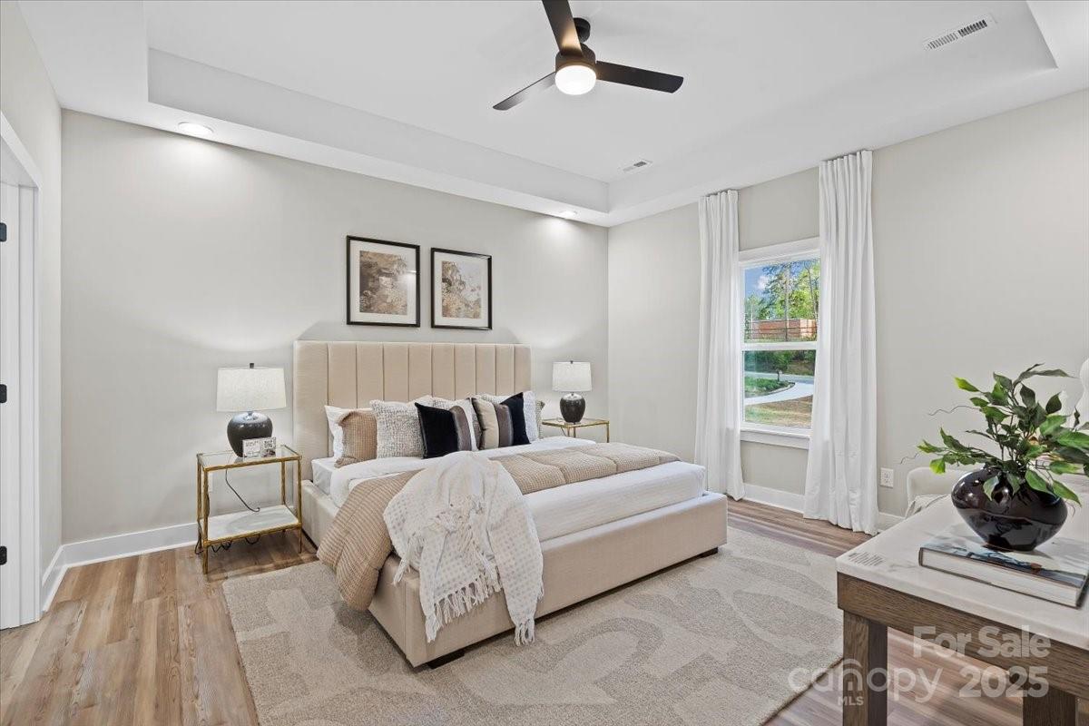 522 Waco Road Kings Mountain, NC 28086 - Photo 13 of 26 a bedroom with a large bed lamp and a potted plant