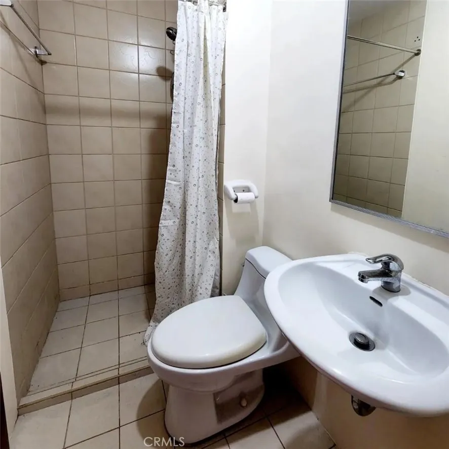 1201 Valderama Tower, Unit 325 Springtown, TX 76082 - Photo 9 of 16 a bathroom with a sink toilet and shower